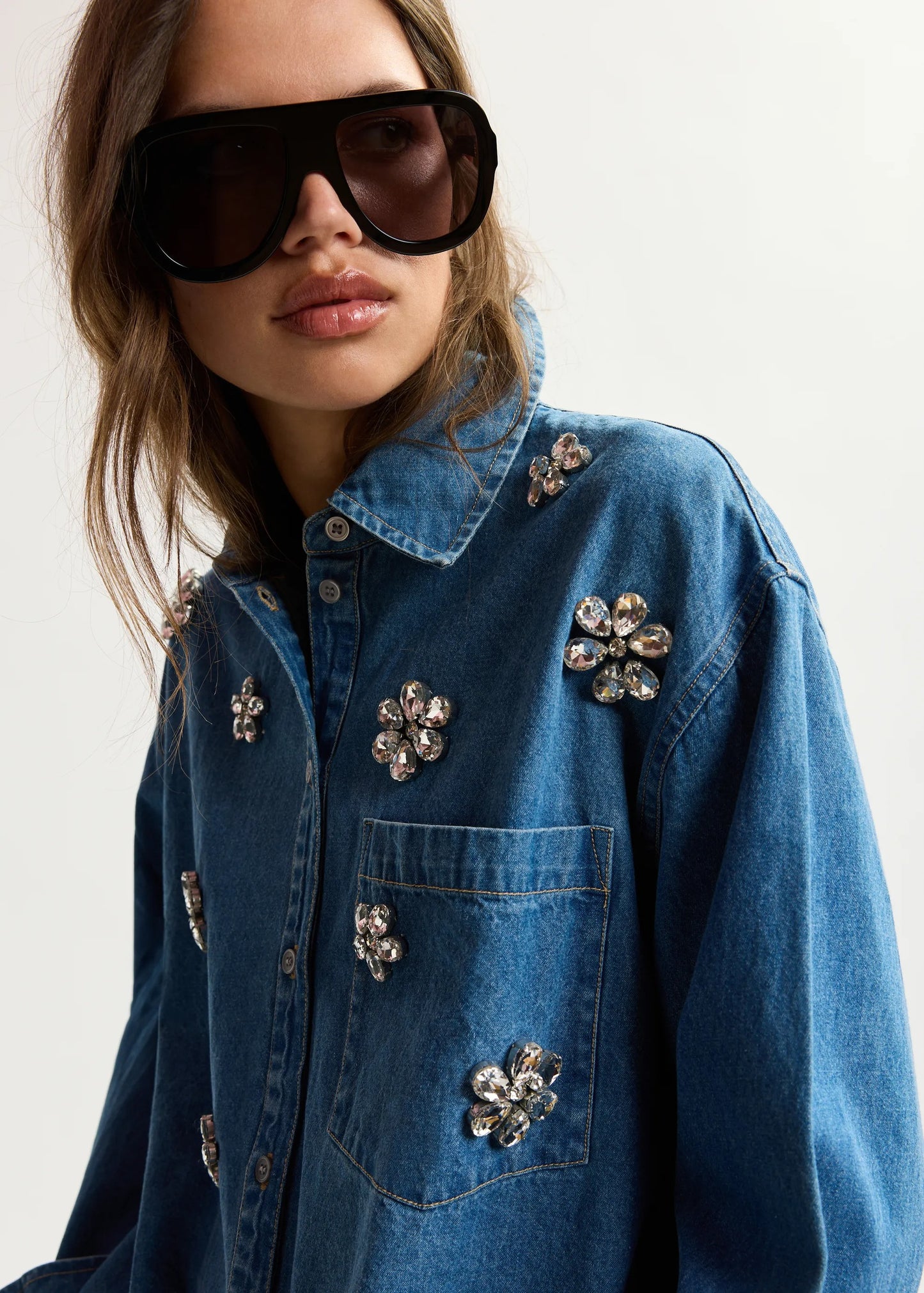 Blue denim shirt with floral rhinestone embellishments from essentiel antwerp