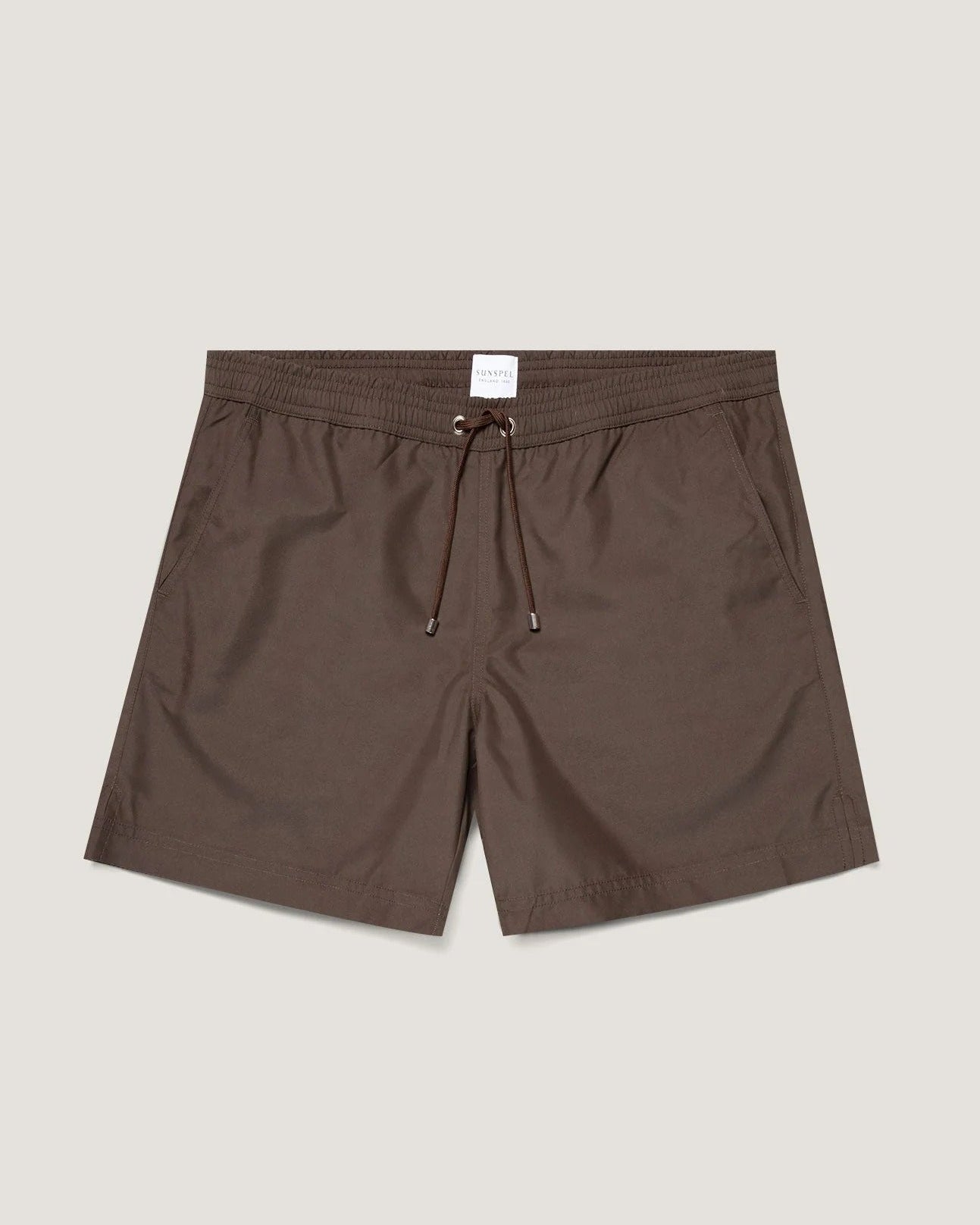 Brown shorts with a drawstring on a light beige background