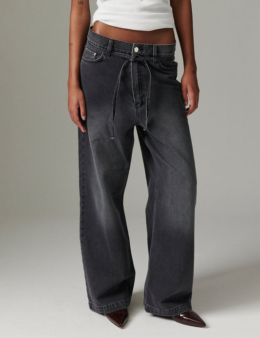 Close view of DAY Birger ét Mikkelsen Elijah Rigid Denim in washed black showing low-rise fit, straight-leg shape, and removable tie belt.