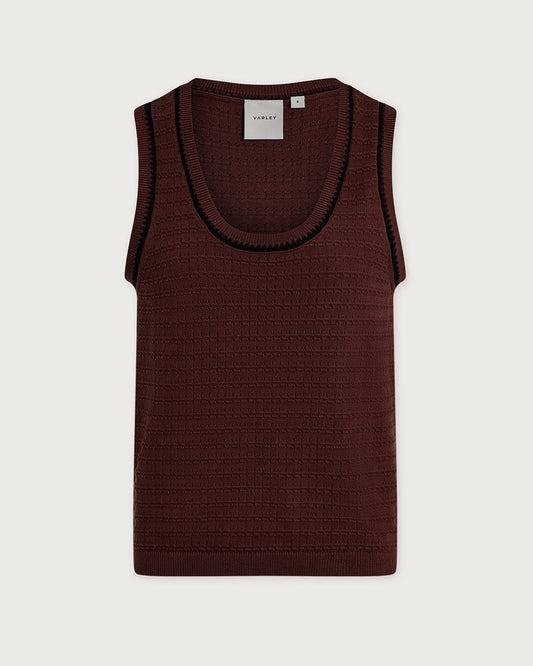 A sleeveless ribbed knit tank top by Varley in deep burgundy, featuring a contrasting black ribbed trim along the scoop neckline, shown flat against a light gray background.