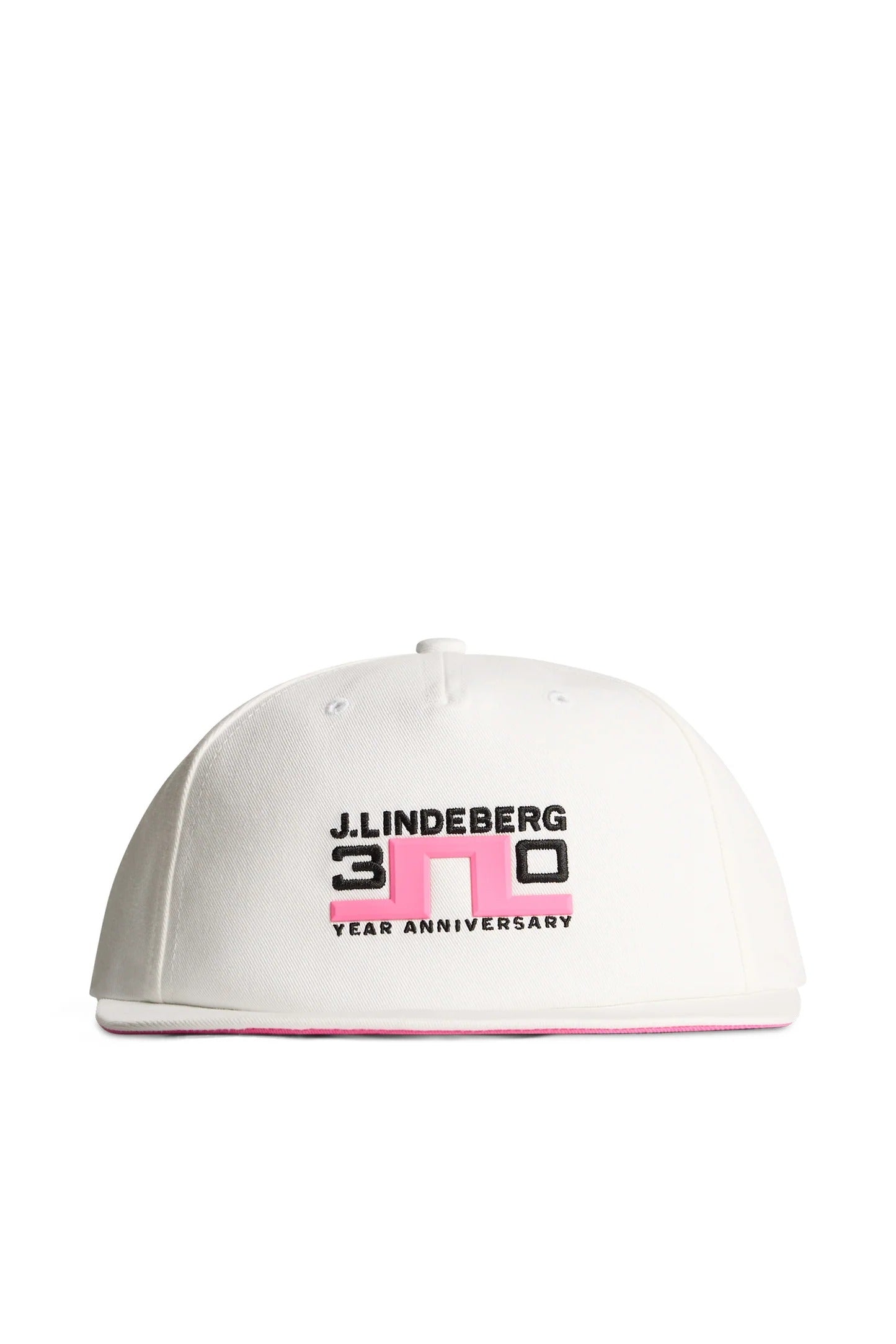 A white J. Lindeberg 30 Year Anniversary baseball cap with black and pink graphic text on the front, shown against a plain white background.
