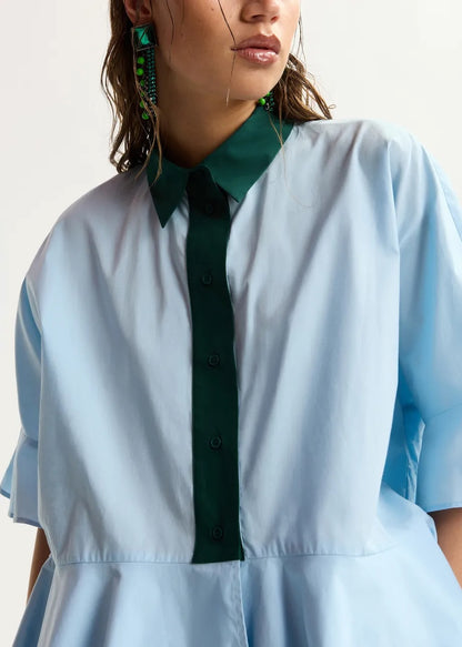 Light blue cotton peplum shirt with dark green contrast detailing
