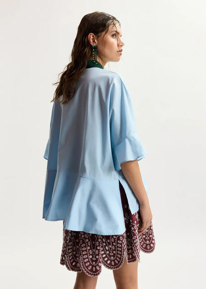 Light blue cotton peplum shirt with dark green contrast detailing
