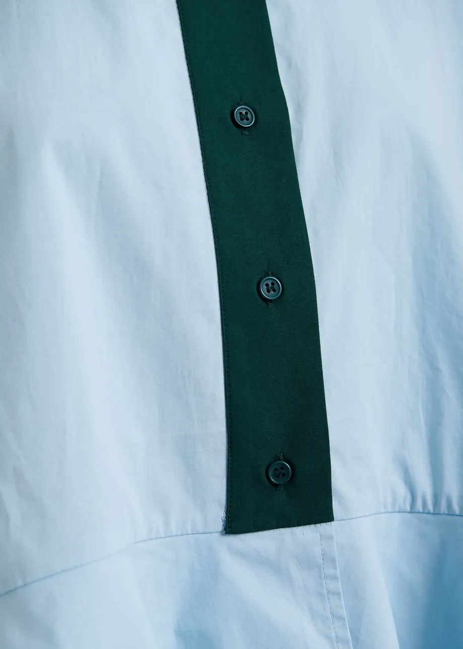 Light blue cotton peplum shirt with dark green contrast detailing
