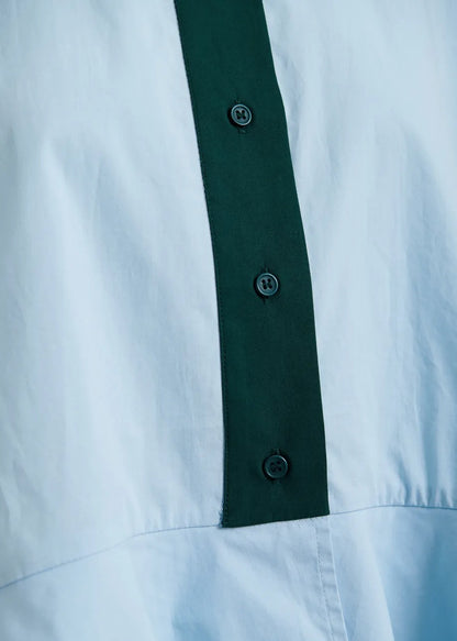 Light blue cotton peplum shirt with dark green contrast detailing
