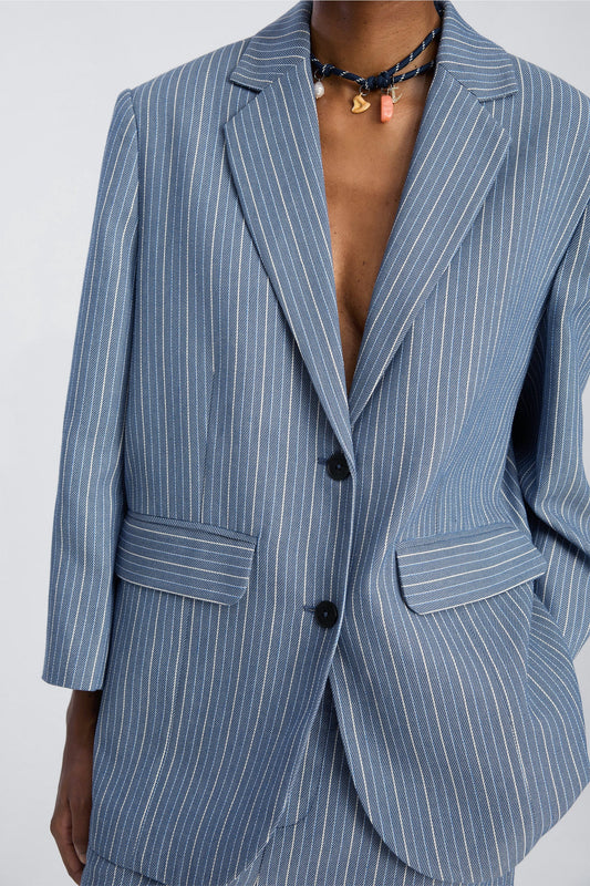 Blue pinstripe suit jacket on a plain background