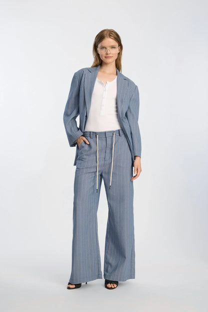 Woman wearing a blue striped outfit on a white background