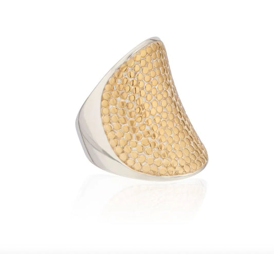 Gold and silver ring with textured design on a white background
